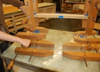 Clamping glued pieced together with a wood stick as a spacer